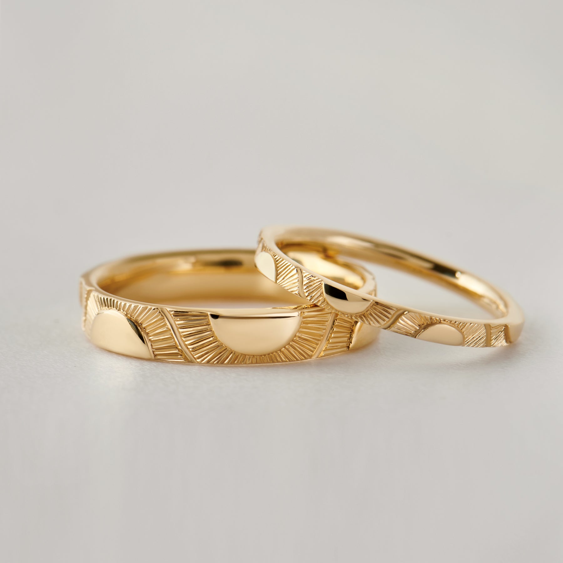 Big-Sun-and-Little-Sun-Hand-Engraved-Wedding-Band-Set-closeup