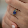 Blue-and-Teal-Sapphire-Cluster-Ring-on-finger-closeup