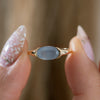 Blue-Mist-East---West-Oval-Milky-Sapphire-Ring-Holding