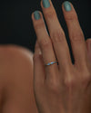 Blue-Sapphire-Tapered-Baguette-Gold-Bar-Ring-on-finger