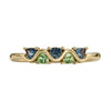 Gold ring with five triangle-shaped gemstones on a white background