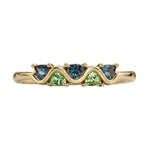 Gold ring with five triangle-shaped gemstones on a white background