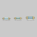 Three gemstones in yellow gold settings with measurements on a gray background