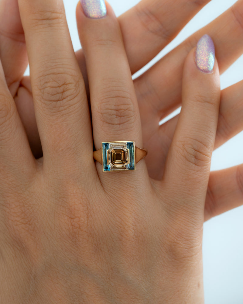 Piet-Fancy-Emerald-Cut-Diamond-Ring-with-Teal---White-Diamond-Halo-Hands