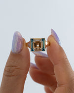 Piet-Fancy-Emerald-Cut-Diamond-Ring-with-Teal---White-Diamond-Halo-Holding