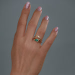 Solitaire-Engagement-Ring-with-a-Pear-Cut-Emerald-in-set-on-finger