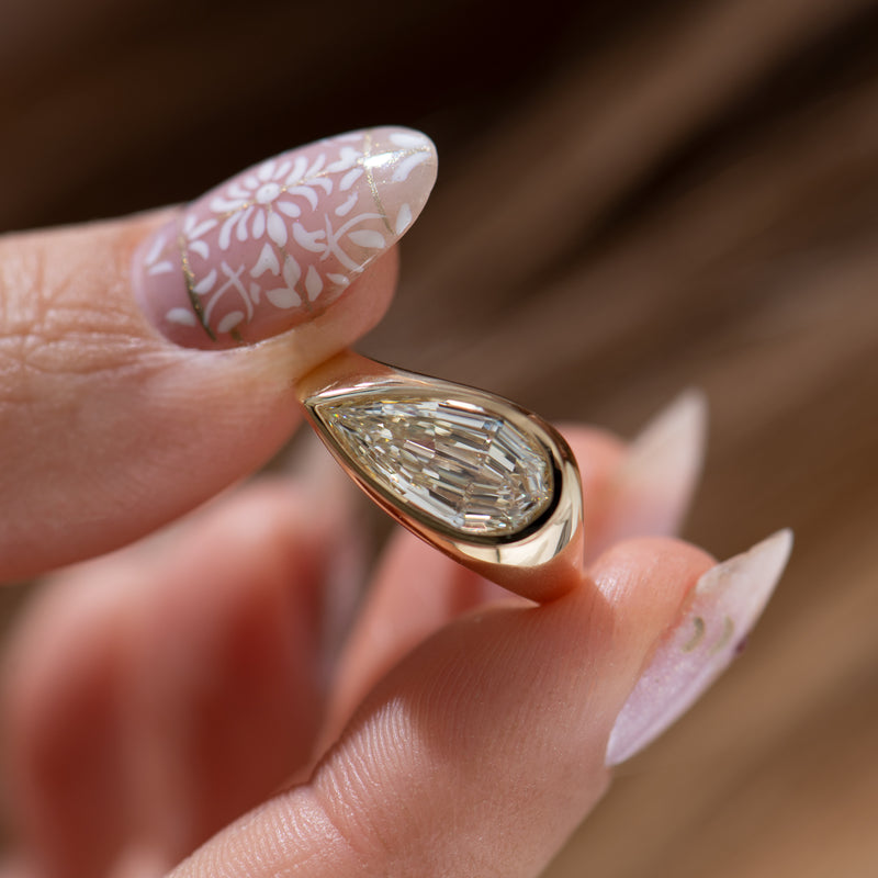 Step-Cut-Pear-Shape-Diamond-Solitaire-Ring-Holding