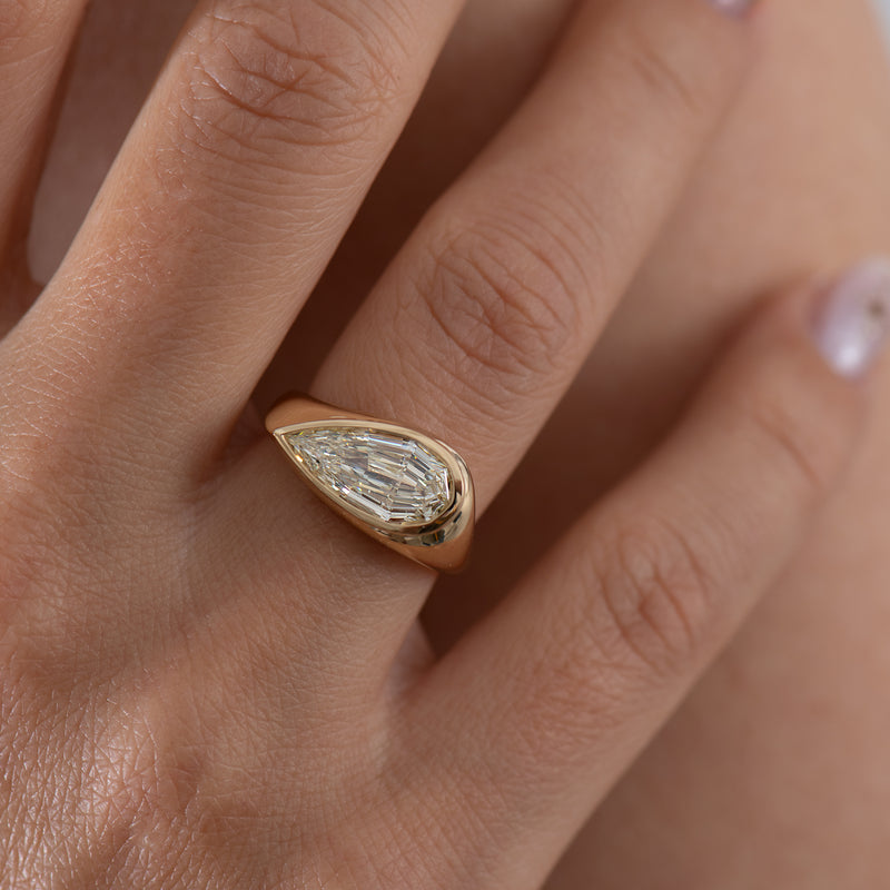 Step-Cut-Pear-Shape-Diamond-Solitaire-Ring-On-Hand