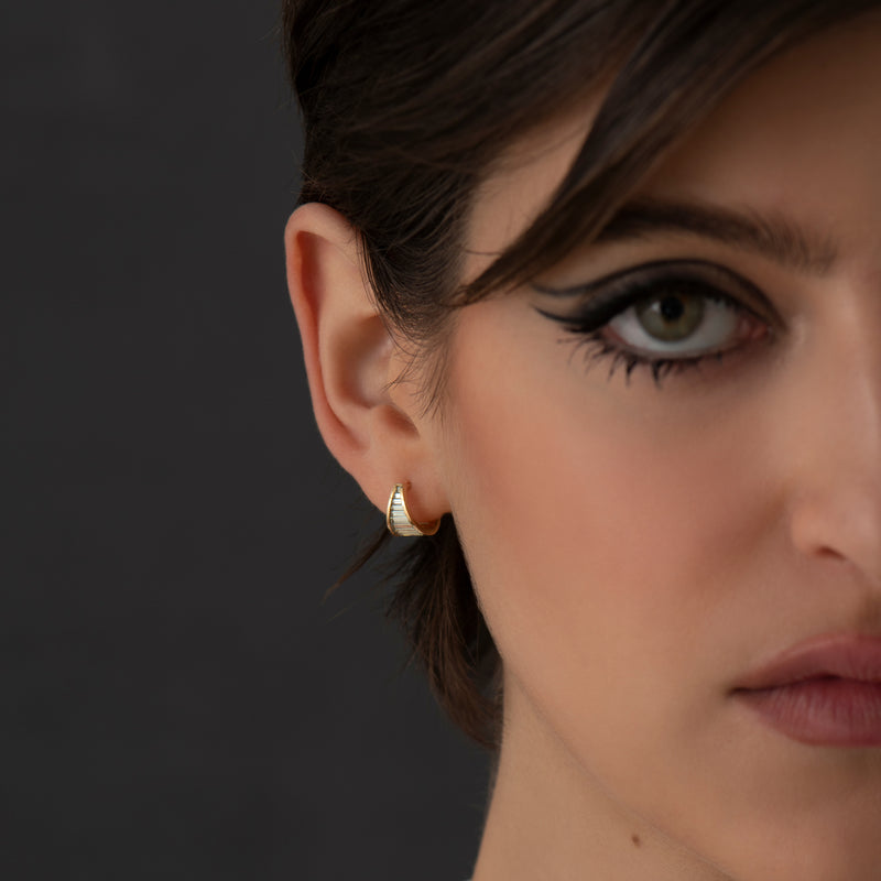 Teal-Baguette-Sapphire-Huggie-Earrings-On-Model-Far