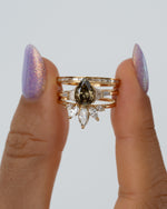 Vetiver-Fancy-Color-Pear-Diamond-Engagement-Ring-Holding-Set_214e2c9f-cfdb-4170-8328-0363788b0ecb