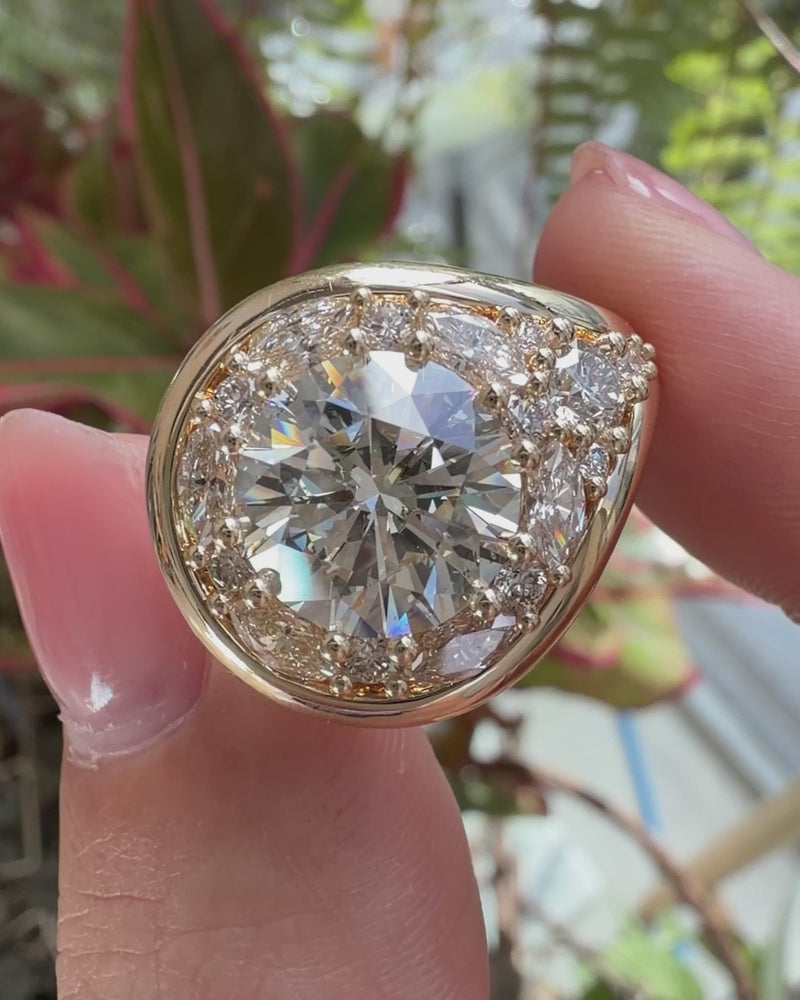 Gold_Halo_Engagement_Ring_with_a_Lassoed_4_Carat_Diamond_Video_Holding