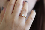 Close Up Of Asymmetric Diamond Cluster Engagement Ring with Aquamarine And Mint Garnet