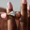 Asymmetrical-Baguette-Cluster-Ring-with-Round-Diamond-Beams-closeup-on-finger