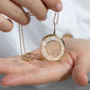 Baguette-Diamond-Necklace-with-a-Fluid-Sphere-Pendant-on-hand