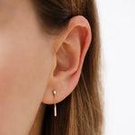 Baguette Diamond Drop Earrings on Ear Up Close 
