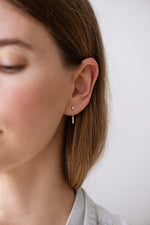 Baguette Diamond Drop Earrings on Ear Front View 