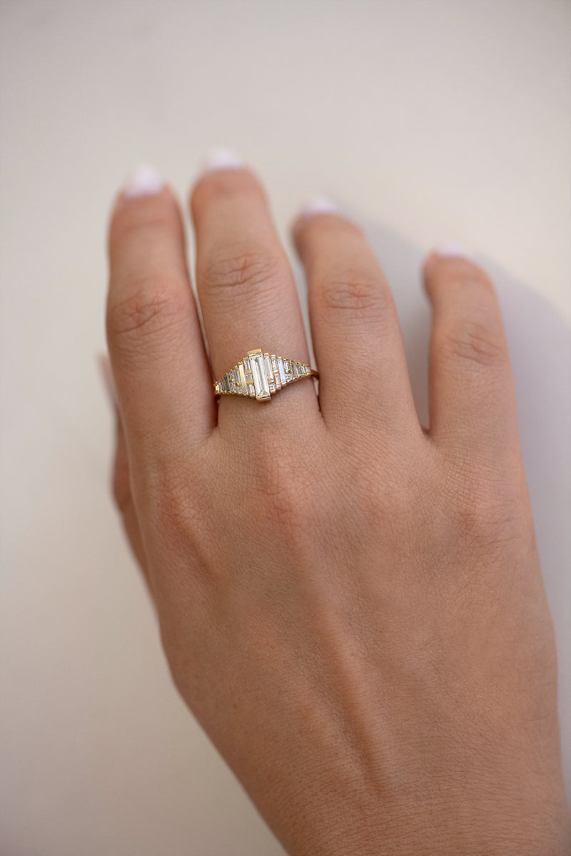 Baguette Diamond Ring with Gradient Diamonds and Gold Details on Hand top view 