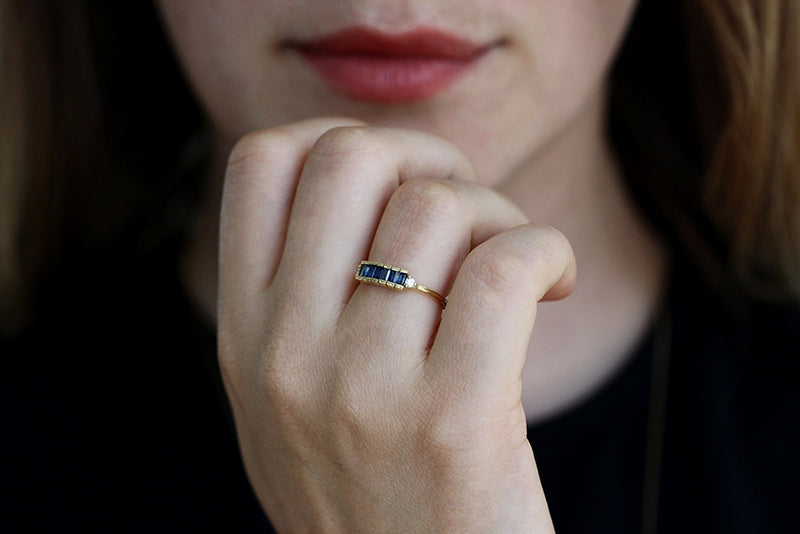 Blue Sapphire Baguette Engagement Ring On Woman's Finger