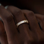 Bridge-Eternity-Band-with-Baguette-and-Trapeze-Cut-Diamonds-on-finger