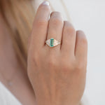 Emerald Ring with needle baguette Diamonds on finger