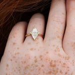 Diamond-Rhombus-Engagement-Ring-with-Triangle-Cut-Diamonds-close-up-on-hand