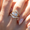 Dual-Diamond-Engagement-Ring-with-a-Cluster-of-Brilliant-Cut-Diamonds-set-on-finger