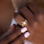 Elemental-Engagement-Ring-with-Diamonds-and-Pearls-on-finger