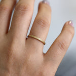 Engraved Geometric Pattern Wedding Band on Hand Up Close View