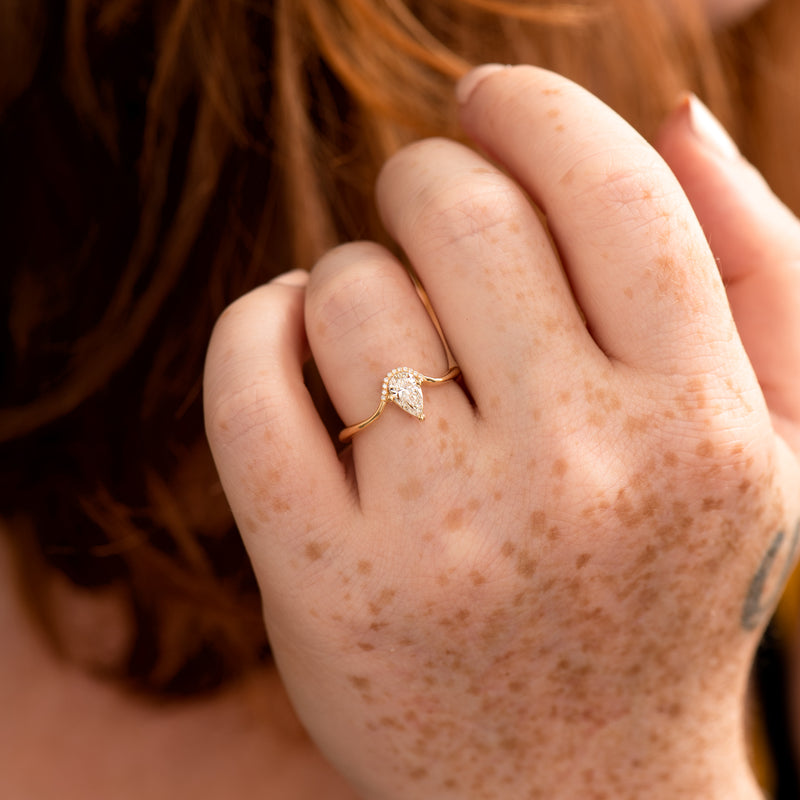 Floating-Pear-Cut-Diamond-Engagement-Ring-in-a-Classic-Style-freckles