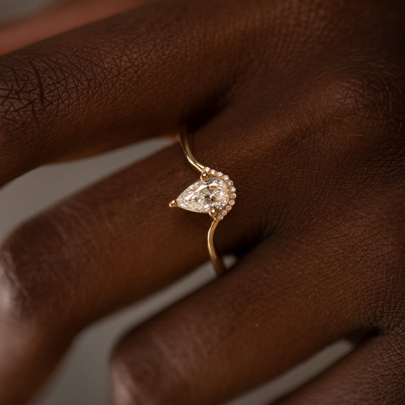 Floating-Pear-Cut-Diamond-Engagement-Ring-in-a-Classic-Style-on-finger