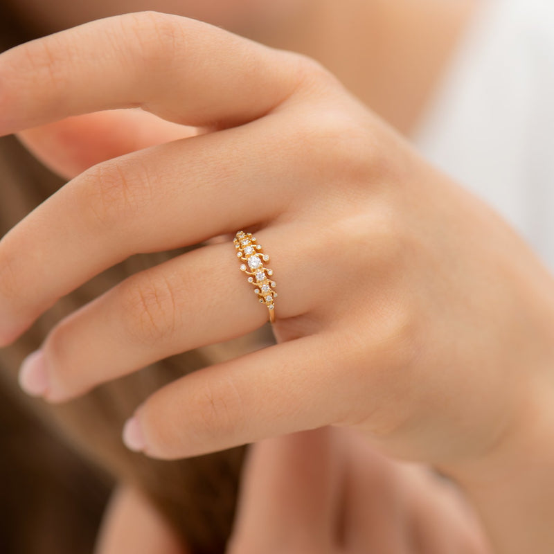 Gold-Orbit-Ring-with-Brilliant-Cut-White-Diamonds-on-finger