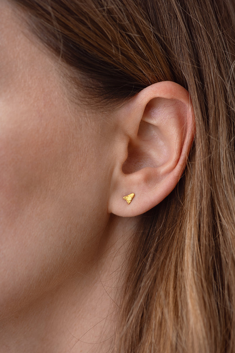 Gold Stud Earring - Arrow Earring on Ear Up Close