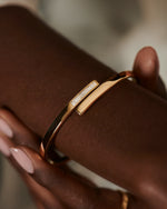 Golden-Spiral-Bangle-with-Inlaid-Baguette-Diamonds-on-finger