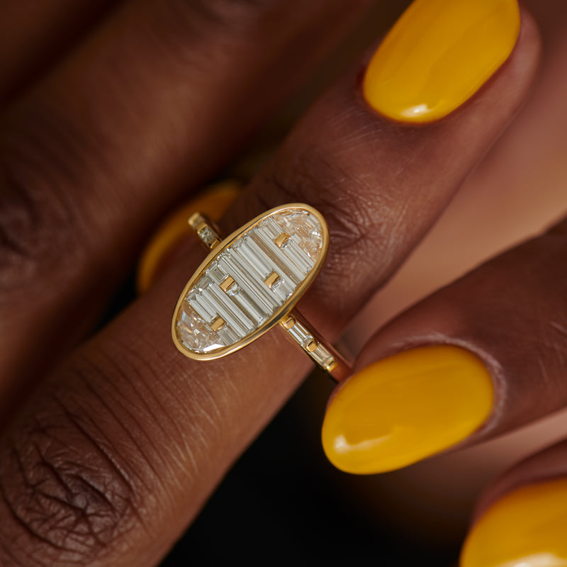 Golden-Vessel-Engagement-Ring-with-Half-Moon-and-Baguette-Diamonds-on-finger