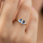 Half-Moon-Sapphire-Engagement-Ring-with-Baguette-Cut-Diamond-on-finger-side-shot