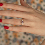 Hexagon-Cut-Spinel-Engagement-Ring-in-Mauve-with-Diamonds-on-finger