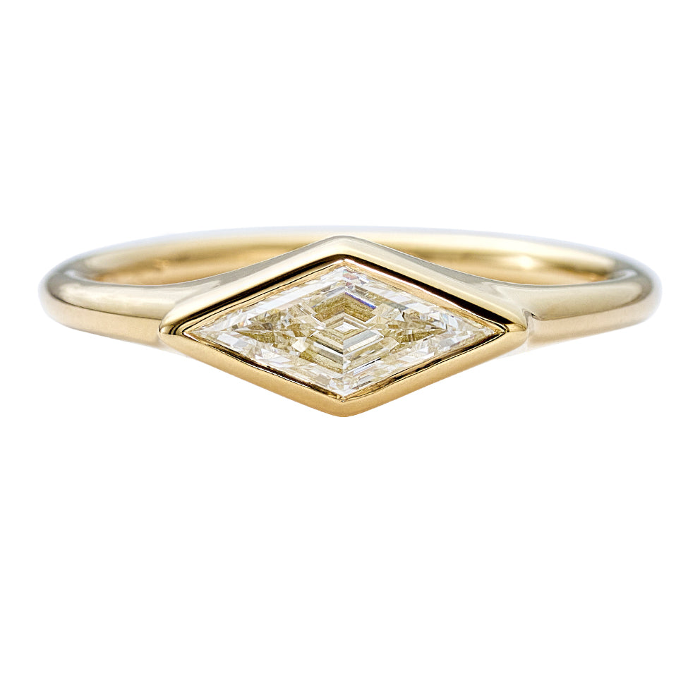 Lozenge-Cut-Diamond-Engagement-Ring-with-a-Golden-Bezel-closeup
