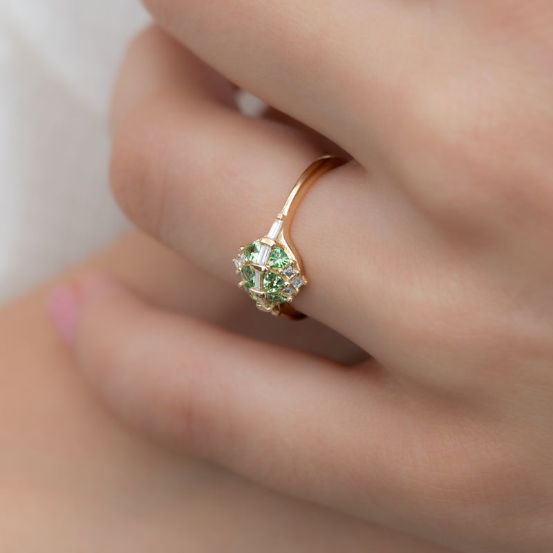 Mint-Garnet-and-Diamond-Cluster-Engagement-Ring-side-shot-on-finger