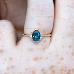 OOAK-Oval-Cut-Teal-Sapphire-Engagement-Ring-with-White-Diamond-Wings-freckles-moment