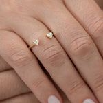 Open-Wedding-Ring-with-Two-Diamond-Hearts-Nesting-Wedding-Band-on-finger