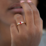 Padparadscha-Sapphire-Engagement-Ring-with-Baguette-Diamond-Detailing-on-finger