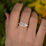 Pyramid-Engagement-Ring-with-Trillion-and-Trapeze-Cut-Diamonds-on-finger