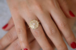 Round Engagement Ring with Long Tapered Baguette Diamonds on Hand front view 