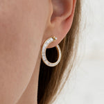 Spiral-Hoop-Earrings-with-Tapered-Baguette-Diamonds-closeup-shiny