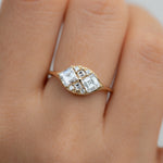 Step-Cut-Engagement-Ring-with-Eight-Square-Diamonds-closeup-on-finger
