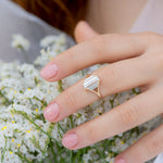 Symmetry-Engagement-ring-with-Five-Baguette-Cut-Diamonds-on-finger