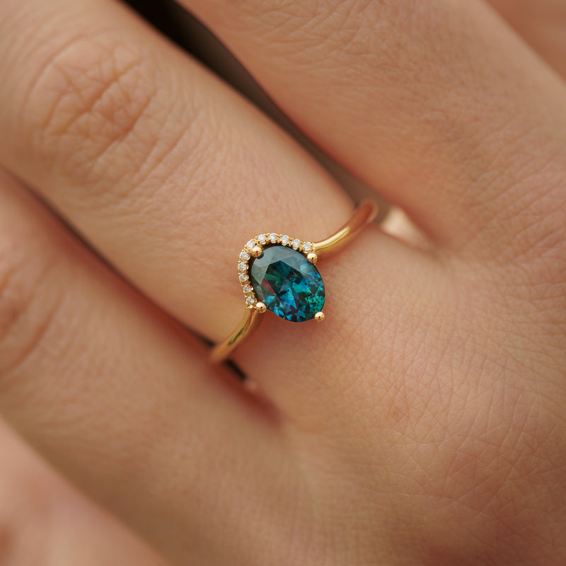 Teal-Sapphire-Engagement-Ring-One-Carat-on-finger
