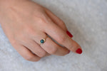 Teal Sapphire Ring with Baguette Diamond Wings on Hand other view up close 