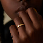 The-Mountain-Climbers-Gold-Wedding-Band-on-finger