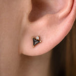 Triangle Earrings with Black and White Diamonds on ear up close 